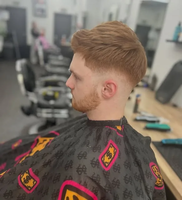 Copper textured crop with a clean mid fade, side profile in the shop