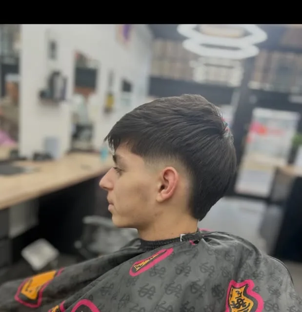 Textured fringe with a taper fade under the shop's honeycomb lights
